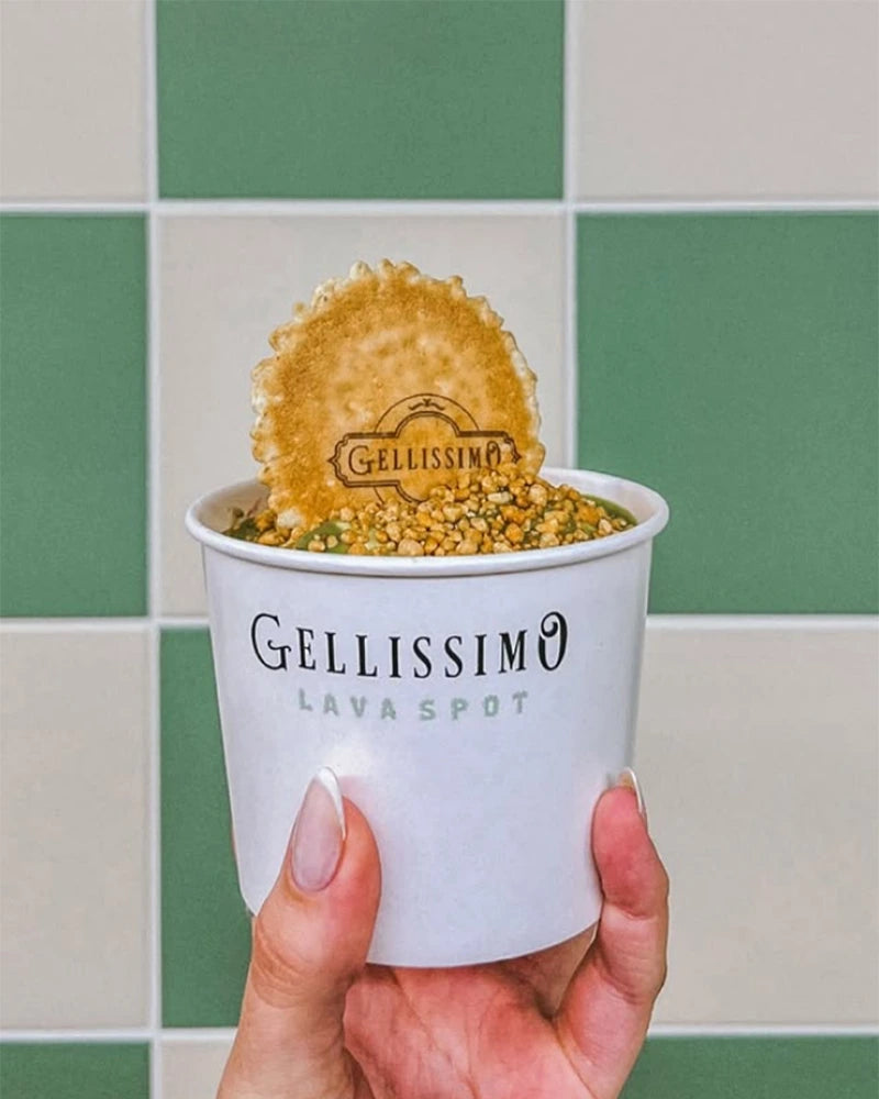 Hand holding ice cream with lava pistachio
